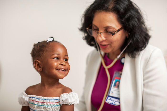 Young girl getting checked by provider